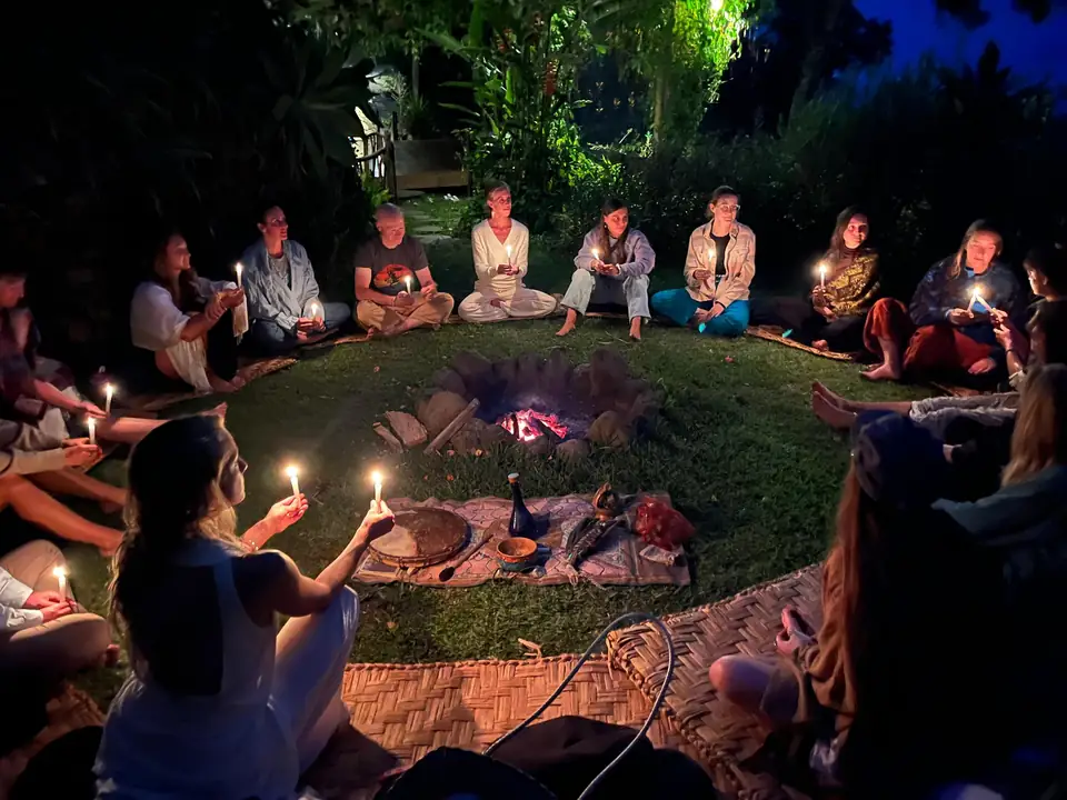 A candlelit evening circle around the fire at Casa Kula
